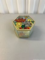 Closed hexagonal trinket box showing painted Noah’s Ark lid scene