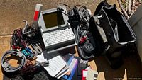 Overall view of Network Probe 7100 with cables, bag, manuals, floppies