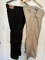 Both pairs hanging: black Levi’s jeans and khaki Denver Hayes pants
