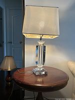 Full view of crystal table lamp on round side table