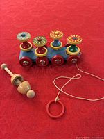 Brio pull toy with rattle on red cloth