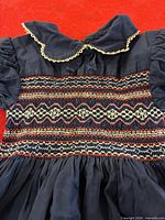 Close-up of bodice showing smocking, collar lace, sleeve detail