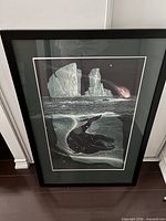 Full view of framed print leaning against wall