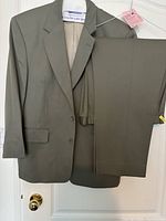 Full view of jacket and trousers on hanger showing color and style