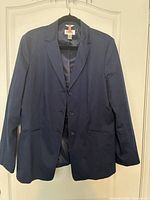 Front view of navy blazer on hanger