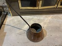 Overall view of copper dipper pot showing body shape and handle