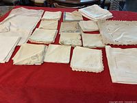 Overall lot of white and ivory linens on red background