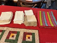Stacks of white and beige linens alongside striped runner