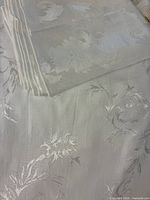 White damask tablecloth and stacked white napkins