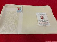 Folded white Marghab linen tablecloth with Marghab card and inspection tag visible