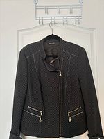 Full front view of brown/black patterned Gerry Weber jacket on hanger showing overall style and zipper details