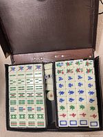 Open case showing full tile set in trays