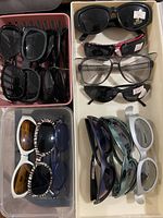 Overview of entire lot showing grouped sunglasses in trays
