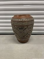 Front view of terracotta vase showing geometric pattern and overall shape