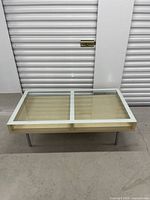 Full view of table showing glass split top and birch frame