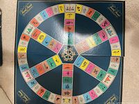 Folding Trivial Pursuit game board opened flat