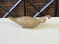 Side view of quail figurine