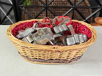 Top view of basket filled with assorted metal and red plastic cookie cutters