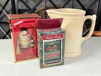 Pitcher beside two boxed ornaments