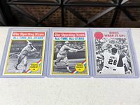 All three Topps baseball cards in top-loaders side by side