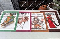 All four mounted magazine cover prints laid out on table