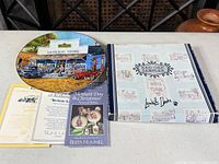 Front view of plate, box, certificate and brochure