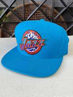 Front view showing teal colour and embroidered Utah Jazz logo