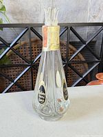 Full view of decanter showing labels, foil, and three pour spouts