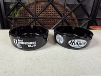 Both ashtrays top view showing main logos