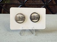 Front view of the two matching circular US pins on display card