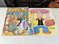 Overview of both Popeye board books and squeeze toy
