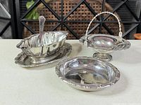 All four silver-plated serveware items grouped