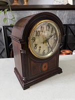 Front angled view of wooden Seth Thomas mantel clock showing dial and case