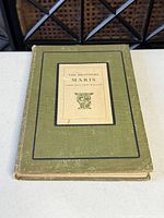 Front cover of olive clothbound hardcover with mounted title panel