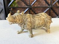 Profile view of metal rhinoceros figurine