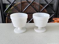 Both milk glass salt cellars side by side showing size, shape and condition