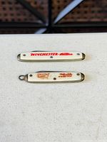 Front view showing both knives with Winchester and Rio Grande logos