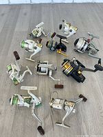 Group shot of all ten spinning reels arranged on floor