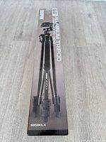 Front of boxed Sunpak 5858DLX tripod showing branding and product image