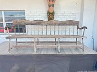 Full view of the long wooden bench on platform