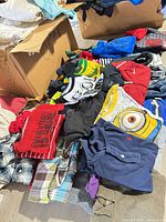 Overview of garments spread out from box showing variety and quantity