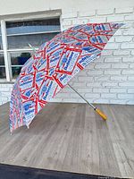 Full view of open Budweiser umbrella on floor