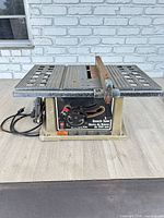 Full view of Delta 10-inch bench table saw showing table surface, fence and power cord