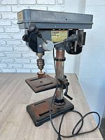 Front view of Central Machinery bench drill press showing head, column, table and power cord