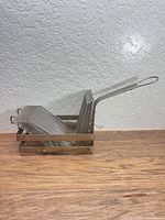 Nested stainless steel basket racks in holder frame