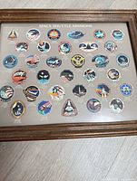 Framed lithograph with printed shuttle mission patches