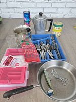 Group shot of cookware, flatware tray, organiser boxes, tumbler, tin and stocking bag