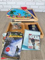 Overall lot showing wooden game board set, tray, comics, catalogue, book and pins