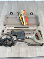 Saw in open case with packaged and loose blades