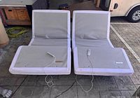 Front view of both adjustable bases with remotes on top